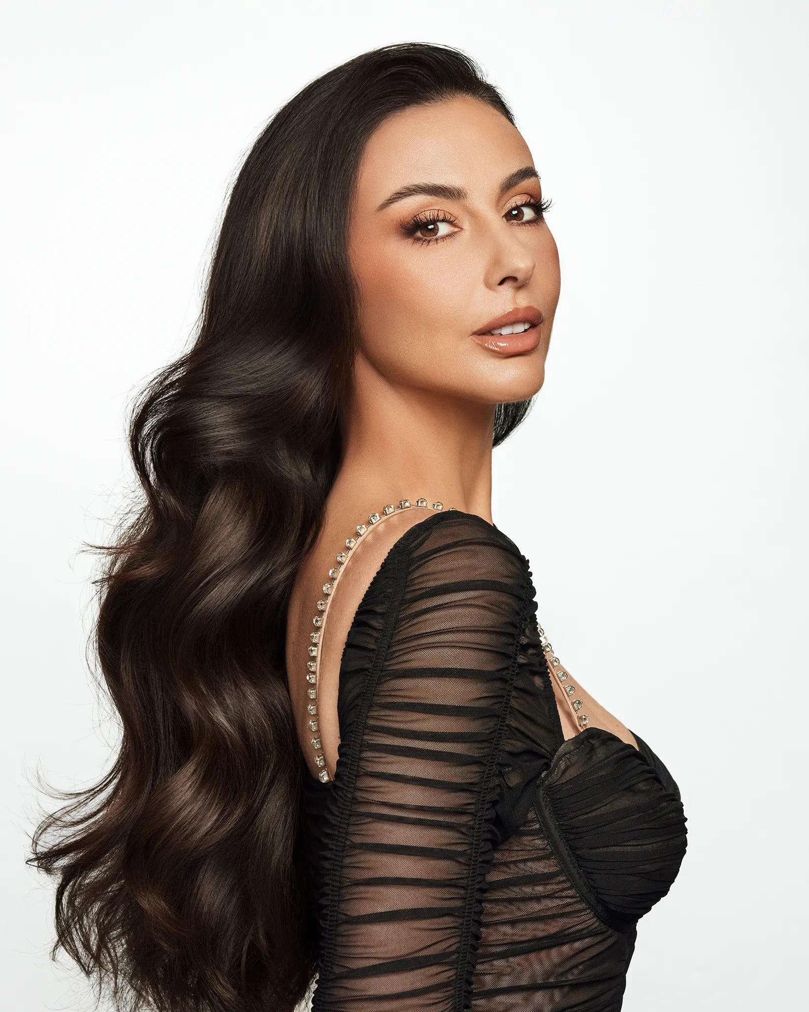 Three-piece Extra Volumizing Boost Set featuring shampoo, volume boost fluid, and argan hair oil in brown and bronze tones, isolated on a white background.