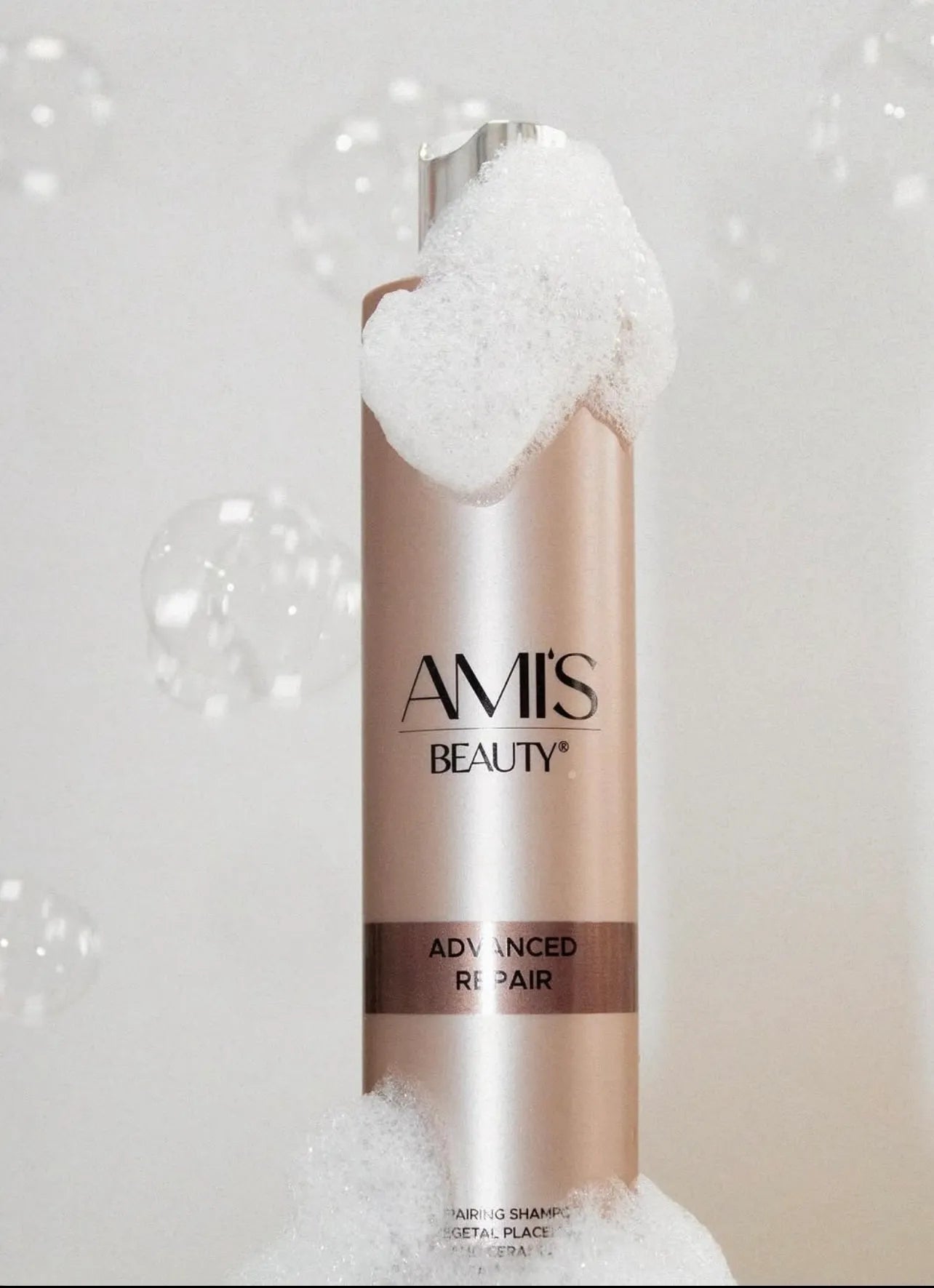 Promotional image featuring a bottle of Advanced Repair Shampoo standing amongst soft white flower petals.